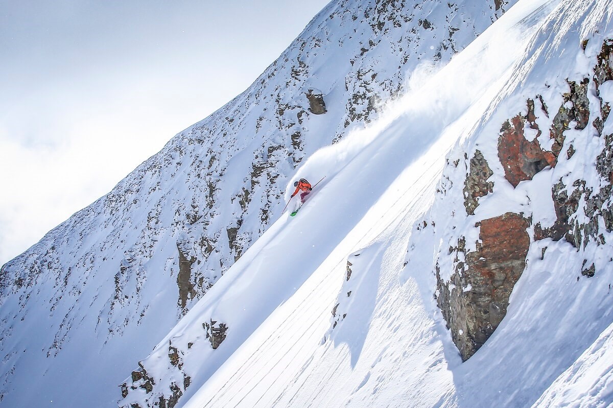 Skifahrer, der im Big Sky Mountain Resort eine Rutsche hinunterkommt