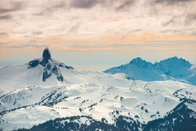 A photo of a mountain peak at sunset.